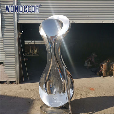 Large rotating stainless steel sculpture outdoor square park